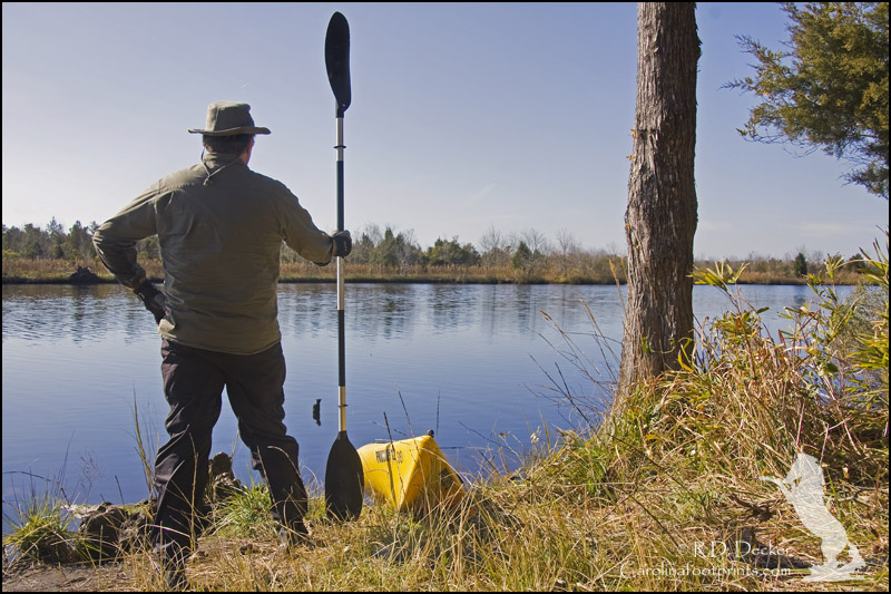 A kayaker surveys the White Oak river at Long Point Landing.